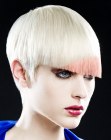 Precision cut platinum blonde hair with a pink color accent
