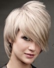 Hairstyle with a long angled fringe and a metallic hair color