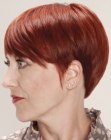 Short mushroom hairstyle for older women with red hair
