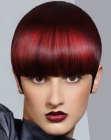 Short helmet haircut in an intense red hair color