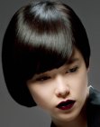 Shiny black hair cut into a short asymmetrical style