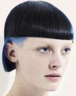 Backwards basball cap shape haircut with a blue undercut