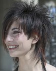 Short layered haircut with streaks of longer hair throughout
