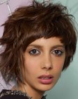 Short haircut with intense texture and short curved bangs