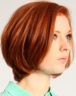 Short haircut with a longer neck section and sides that curve inward