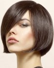 Chin length bob with diagonal bangs and a curve