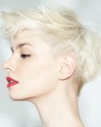 Blonde pixie with a clipper cut nape and spiked up hair