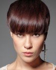 Pixie cut with wide bangs that cover the eyebrows
