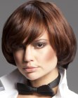 Short round haircut with curved bangs and a satiny shine