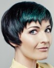 Short black hair with greenish blue streaks