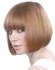 Chin length bob with full bangs for reddish blonde hair