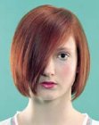 Red hair cut into a chin length bob with textured ends