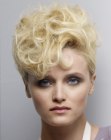 Short blonde hair styled into curls for volume