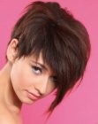 Brunette pixie cut with a long forelock and razor-cut layers