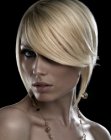 Steeply-angled blonde bob with convex cutting lines and razor-cut layers