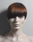 Short and sleek chestnut color hair with a blunt angled fringe