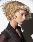 Angled haircut with a shorter back and blonde curls