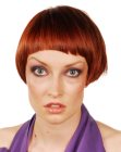Short red hair with asymmetry and super short bangs