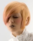 Short geometric hairdo with a rounded back and a dramatic hair color