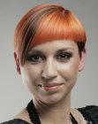 Daring hairstyle with angled bangs and a tangarine hair color