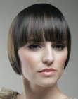 Short jaw length bob with blunt over the eyebrows bangs