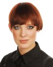 Short asymmetrical style with bangs for sleek red hair