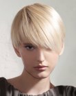 Modern short haircut with angled bangs for blonde hair