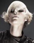 Blonde razor-cut stacked bob with elongated bangs
