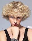 Sporty short hairstyle with blonde curls and long bangs