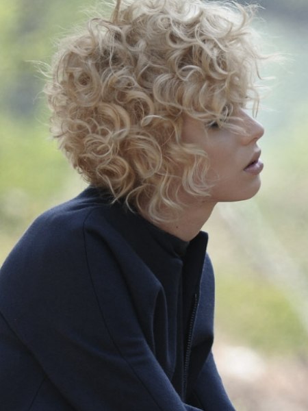 Short blonde hair with a shorter back and curls