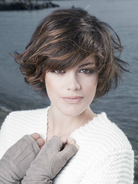 Short hairstyle with the bangs curved across the forehead