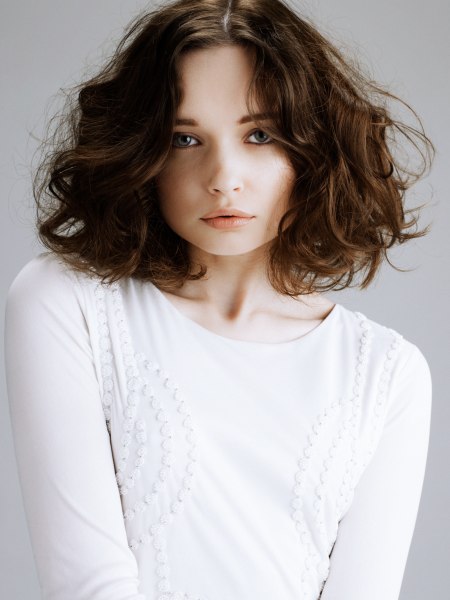 Brunette bob with large waves and a center part