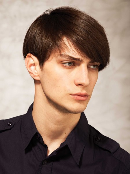 Men's hairstyle with exposed ears and a long fringe