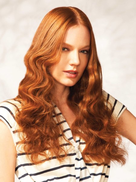 Long copper color hair with a sleek section and curls