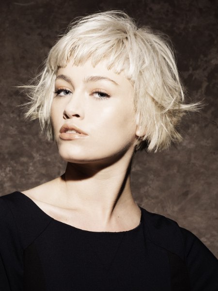 Short blonde bob with half-forehead bangs