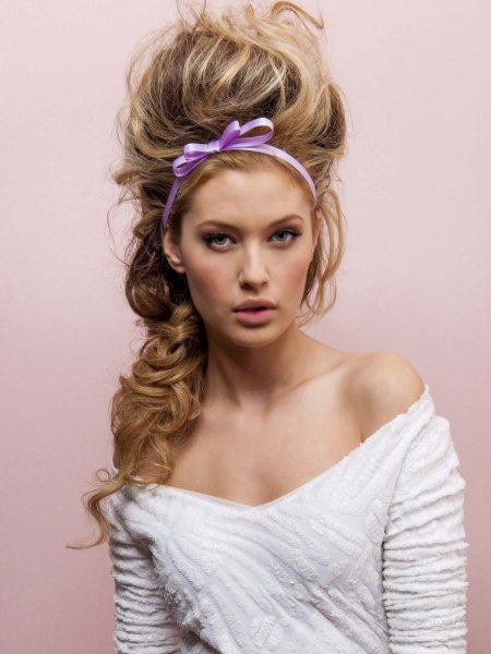 Rapunzel-style updo with a braid that falls over one shoulder