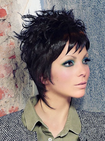 Black pixie hairstyle with strands that hug the neck