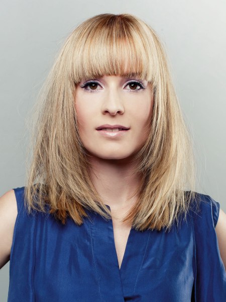 Long blonde hair with tapered lines and highlights