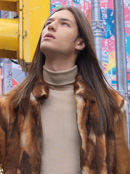 Man with very long hair and a turtleneck