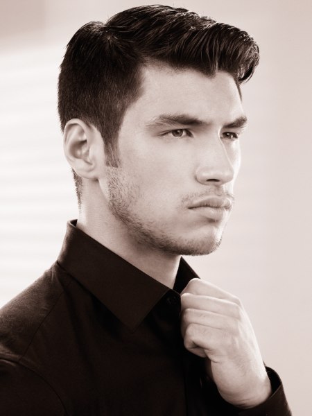 Men's fashion haircut with short sides and longer top hair