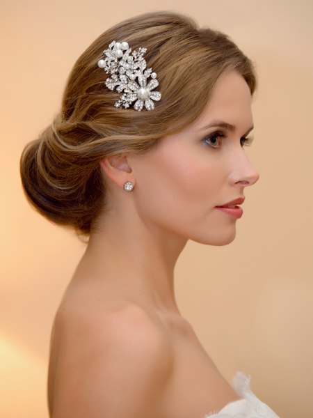 Bridal chignon and a 1940s inspired hair comb with flowers and pearls