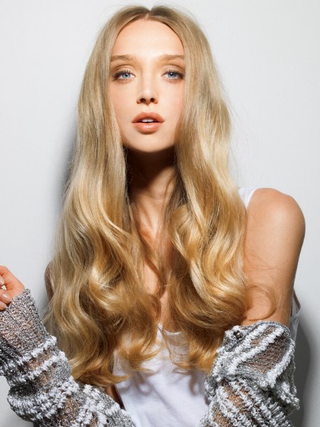 Almost waistline length blonde hair with waves