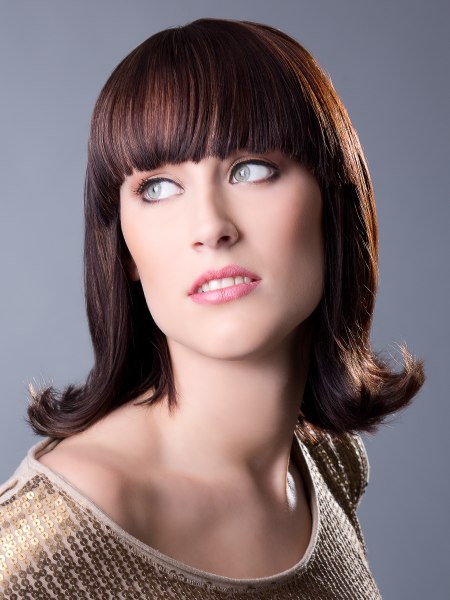 Medium 1960s hairstyle with an outward roll