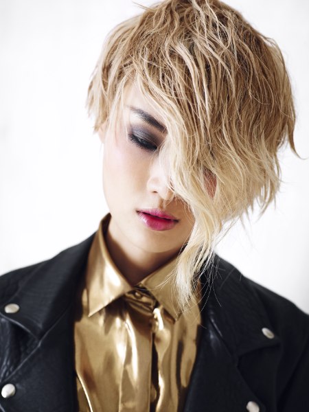 Pixie cut hair and a shiny gold shirt