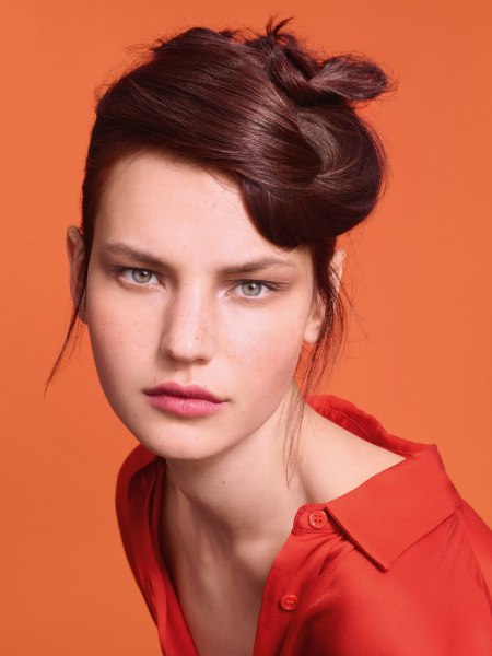 Chignon with loose knots at the top of the head