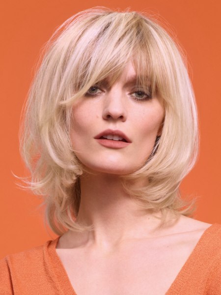 Soft blond bob with layers and bangs