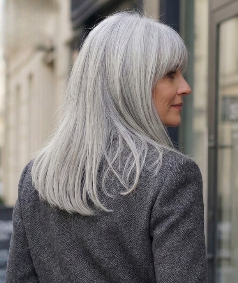 Woman with long gray hair that looks youthful