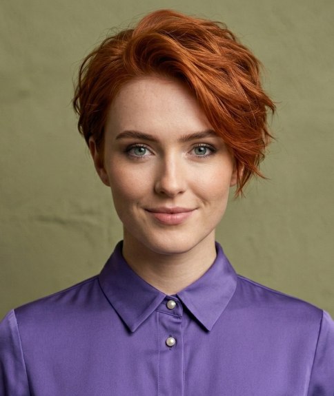 Woman wearing her red hair in a short cut, after her makeover