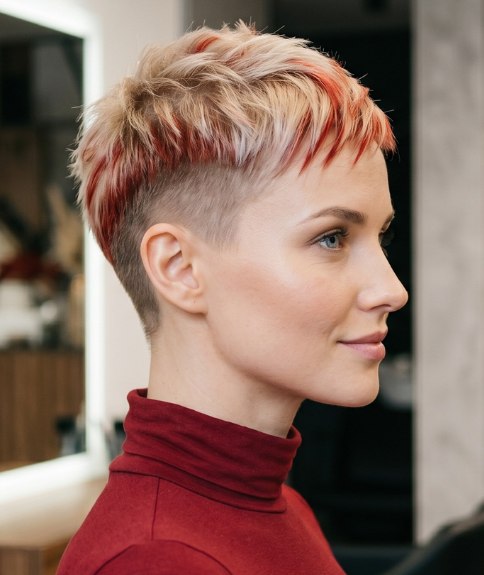 Very short blonde hair with red streaks