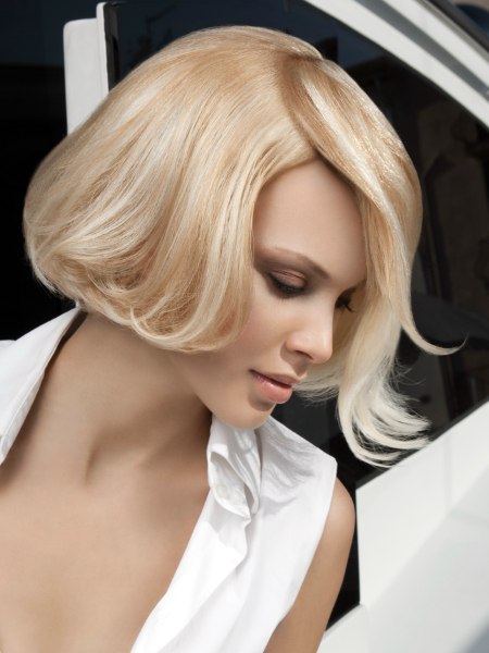 Short blonde bob haircut with an overlapping partition